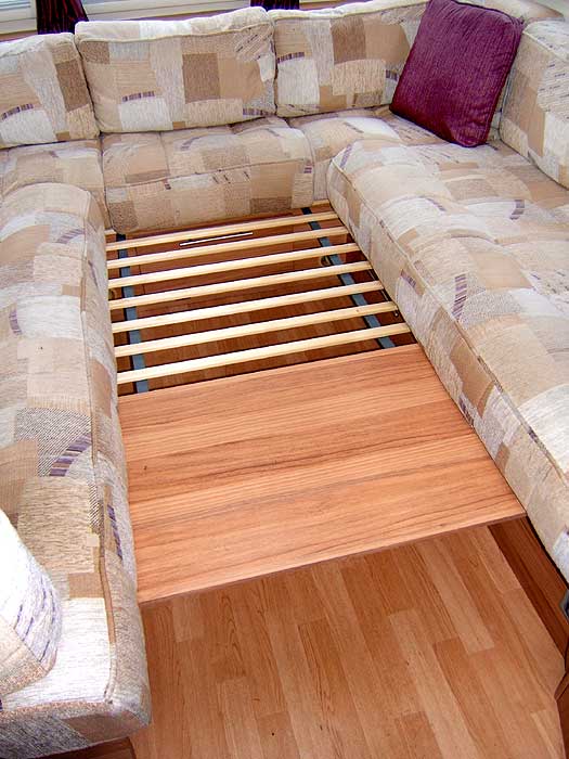 This 'array' of wooden slats pulls out from under the drawer cabinet between the seats and aids the process of converting the front lounge to and from a sleeping area.